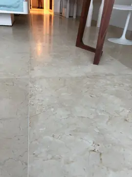 Detalle de pavimento crema con vetas. Primer plano del pavimento pulido en tono crema con vetas, colocado en piezas grandes.